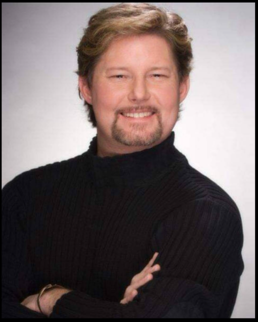 A person in a black sweater Description automatically generated